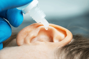 peroxide drops going into an ear